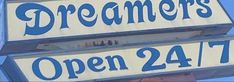 a sign for a restaurant that is open 24 / 7 and has the words dreamers written on it