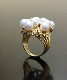 DeKara Designs Collection Beautiful Art Deco/Vintage/Modern Style Halo Diamond Pearl Cocktail Ring. Metal- 14K Yellow Gold, .583. Stones- Nine 6.5 MM Round Tahitian/South Sea Pearls, 20 Round Diamonds F-G Color SI2 Clarity 0.72 Carats. A handmade truly magnificent 14K Yellow Gold Pearl Diamond Ring. There is a beautiful cluster pearl ring with diamonds that are dazzling surrounding the pearls. This ring is perfect! The diamonds are stunning and make the pearls pop! You have a total of nine pearl Luxury White Cluster Pearl Ring, Pearl Ring Gold, Pearl Diamond Ring, Pearl Cocktail Ring, Vintage Modern Style, Gold Pearl Ring, Pearl And Diamond Ring, Gold Art Deco, Deco Vintage