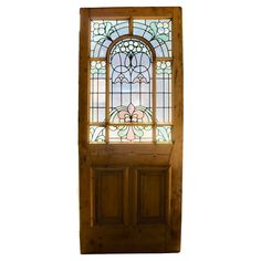 a wooden door with a stained glass window