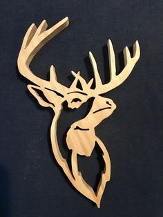 a wooden deer head on a black background