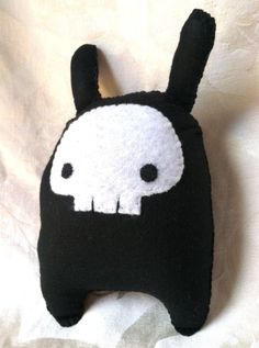 a black and white stuffed animal with two eyes