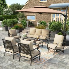 an outdoor patio furniture set with beige cushions