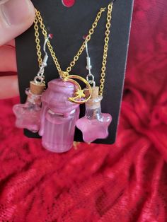 Add a touch of enchantment to your style with this charming Magic Shimmer Potion Bottle Necklace and Earring Set! This whimsical pendant features a miniature glass bottle filled with sparkling shimmer potion, capturing the essence of magic and mystery. The glass bottle is securely sealed and suspended from a dainty chain, perfect for adding a hint of mystical allure to any outfit. Whether you're a lover of fantasy or simply appreciate unique jewelry, this set is sure to bring a touch of magic to your day. Perfect for cosplay or ren faire accesories! ONE OF A KIND PIECE PLEASE NOTE I MAY NOT BE ABLE TO RECREATE THIS SPECIFIC COLOR! (If You Love it.. Get it now!) ;) Each necklace set is a handmade treasure and  truly ONE OF A KIND!  Chains (22.5" long) with easy to use clasps. 925 Sterling S Potion Bottle Earrings, Shimmer Potion, Color Changing Potion, Potion Necklace, Magical Potion, Kawaii Cups, Jar Jewelry, Creepy Crawlers, Map Making