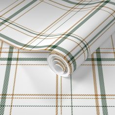 a white and green plaid wallpaper with an orange stripe on the bottom right corner