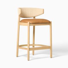 a wooden stool with a tan leather seat and back rest on an isolated white background