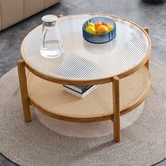 a table with a bowl of fruit on top of it and a book in the middle