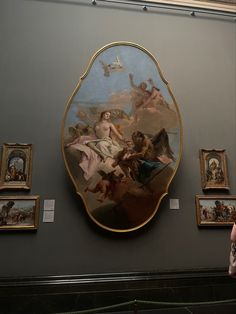 a woman standing in front of a painting on the wall