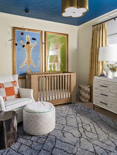 a baby's room with a crib, rocking chair, dresser and art on the wall