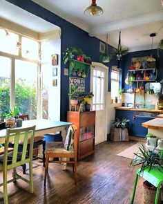 a kitchen with blue walls and wooden floors