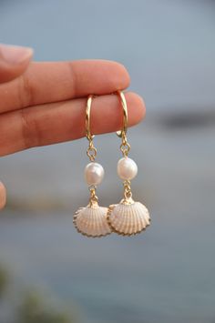 "Gold Dangle shell and pearl hoop earrings, 18k gold filled hoop earings, summer earrings, minimalist hoops, shell earrings, custom earrings The SHEILA earings are perfect for this spring summer. The hoops are in gold filled with fresh water pearl and a real shell with gold filled contour. My jewelry are hand made and done with high quality material. They are hypoallergenic and nickel free. DETAILS: ♥ Lenght 6cm (2.36\") , width  1.6cm (0.62\") ♥ Materials: gold filled 18k, fresh water pearl, shell ♥ style : minimalist If you need any futher information or customisation, feel free to contact me.  THANK YOU" Beachy Jewelry, Preppy Jewelry, Seashell Jewelry, Summer Earrings, Jewelry Lookbook, Summer Earring, Pearl Hoop Earrings, Custom Earrings, Earrings Minimalist