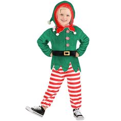 a little boy dressed in an elf costume