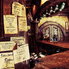 a wooden table topped with lots of writing on it's side next to a bar