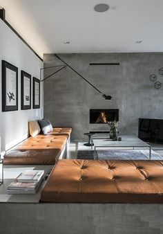 a living room filled with furniture and a flat screen tv on top of a wall