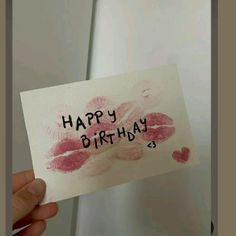 someone holding up a card with the words happy birthday written on it