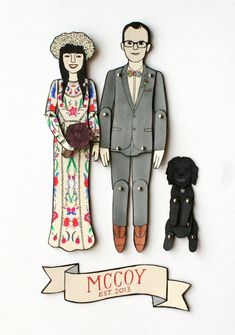 a paper cutout of two people and a dog