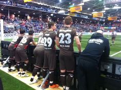 the soccer players are lined up on the sidelines at the stadium for their team's game