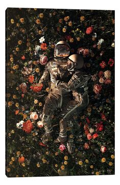 an astronaut is laying on the ground surrounded by flowers