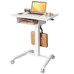 a laptop computer sitting on top of a white stand up desk with wheels and casters