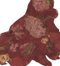 an animal shaped rug with flowers and leaves on it's back end, in red