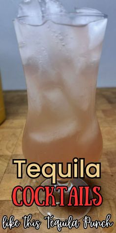 a tall glass filled with liquid sitting on top of a wooden table