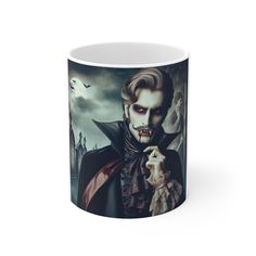 a white coffee mug with the image of dracula holding a doll in it's hand