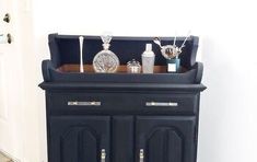 a black cabinet with some silver items on it