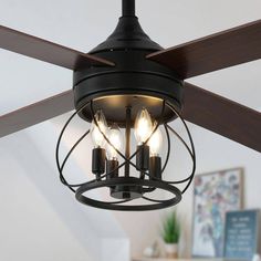 a ceiling fan with three light bulbs hanging from it's center and two lights on each side