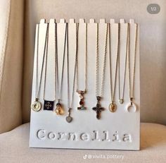 the necklaces are on display in front of a white sign that says cornelia