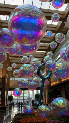 large bubbles are floating in the air inside a building