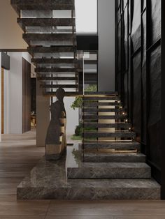 the stairs in this modern house are made of wood and stone, with glass balconies on each side