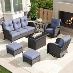 an outdoor patio furniture set with blue cushions and fire pit in the backgroud