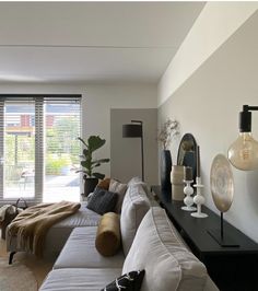 a living room filled with furniture and lots of windows