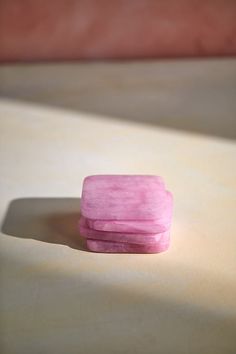 a pink piece of soap sitting on top of a table