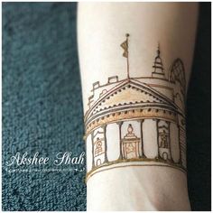 a woman's arm with a tattoo on it that has an image of a building