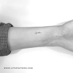 a woman's arm with a small tattoo on the left side of her wrist