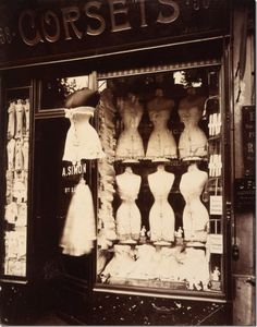 an old fashion store front with mannequins in the window