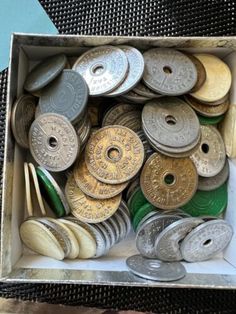 a box filled with lots of different types of buttons