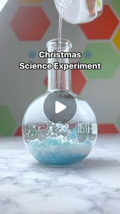 a person is pouring something into a beakle with water in it and the words christmas science experiment