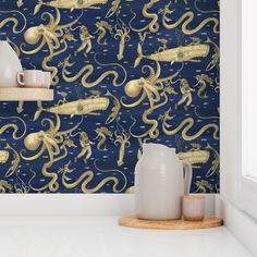 an octopus wallpaper in a kitchen with blue walls and gold designs on the wall