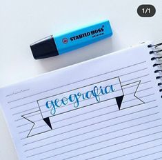 a notepad with writing on it next to a blue marker and a black pen