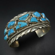 VINTAGE ZUNI BRACELET DESCRIPTION:  Clustered cabs of gorgeous blue turquoise, this bracelet will be a cherished addition to your collection of fine vintage Native American jewelry. MEASUREMENTS: Interior of the cuff measures 5 1/4" with an additional 1 1/2" slightly adjustable gap. Total circumference:  6 3/4" Measures 2 1/4" straight across the widest part  (from wrist bone to wrist bone) Bracelet face measures 1 1/8" wide (the face of the bracelet, north to south) WEIGHT:  62.9 grams SIGNED: Classic Handmade Turquoise Bracelets, Antique Turquoise Bangle Cuff Bracelet, Vintage Turquoise Bracelets As Gift, Vintage Turquoise Bangle Cuff Bracelet, Antique Blue Bracelet Jewelry, Vintage Gemstone Cuff Bracelet Collectible, Vintage Blue Bangle Bracelets, Vintage Gemstone Cuff Bracelet As Gift, Vintage Blue Bracelet For Formal Occasions