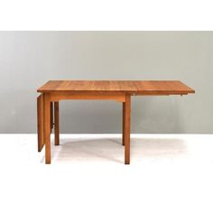 a wooden table sitting on top of a white floor