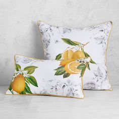 two pillows with lemons and leaves on them