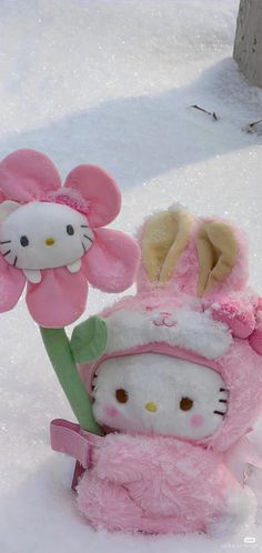 hello kitty stuffed animal and flower in the snow