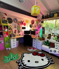 a hello kitty rug in the middle of a room with lots of clutter on the floor