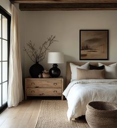 a white bed sitting next to a window in a bedroom