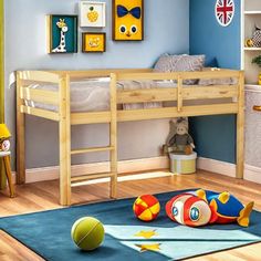 a child's bedroom with blue walls and wooden bunk beds, toys on the floor