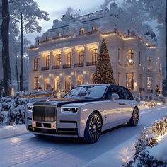 a white rolls royce parked in front of a large house with christmas lights on it