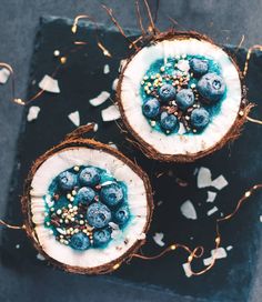 two coconuts filled with blueberries and sprinkles