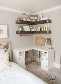 a white desk with shelves above it and some pictures on the wall in front of it